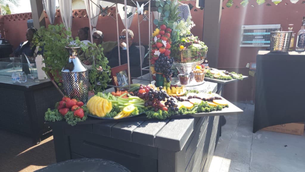 Upscale outdoor catering event with fruit tower centerpiece in Corona