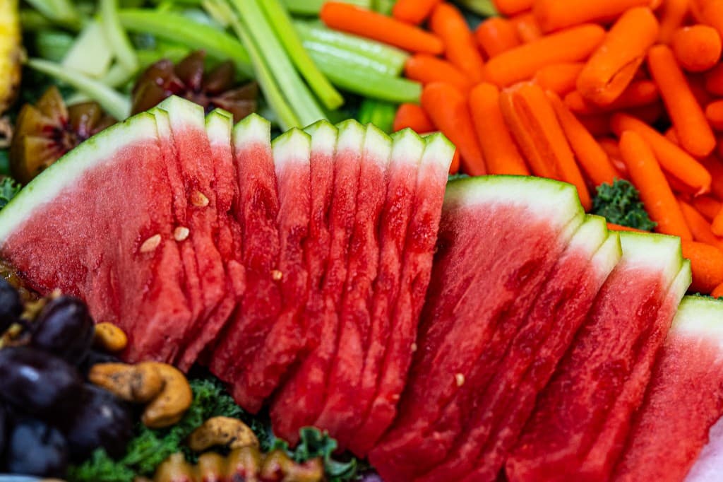 Watermelon slices served alongside carrots and celery
